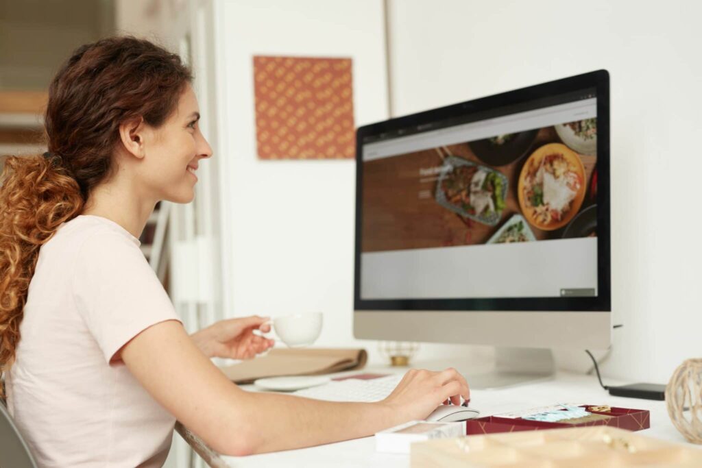 Web designer at a computer working on website redesign