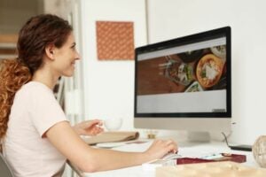 Web designer at a computer working on website redesign