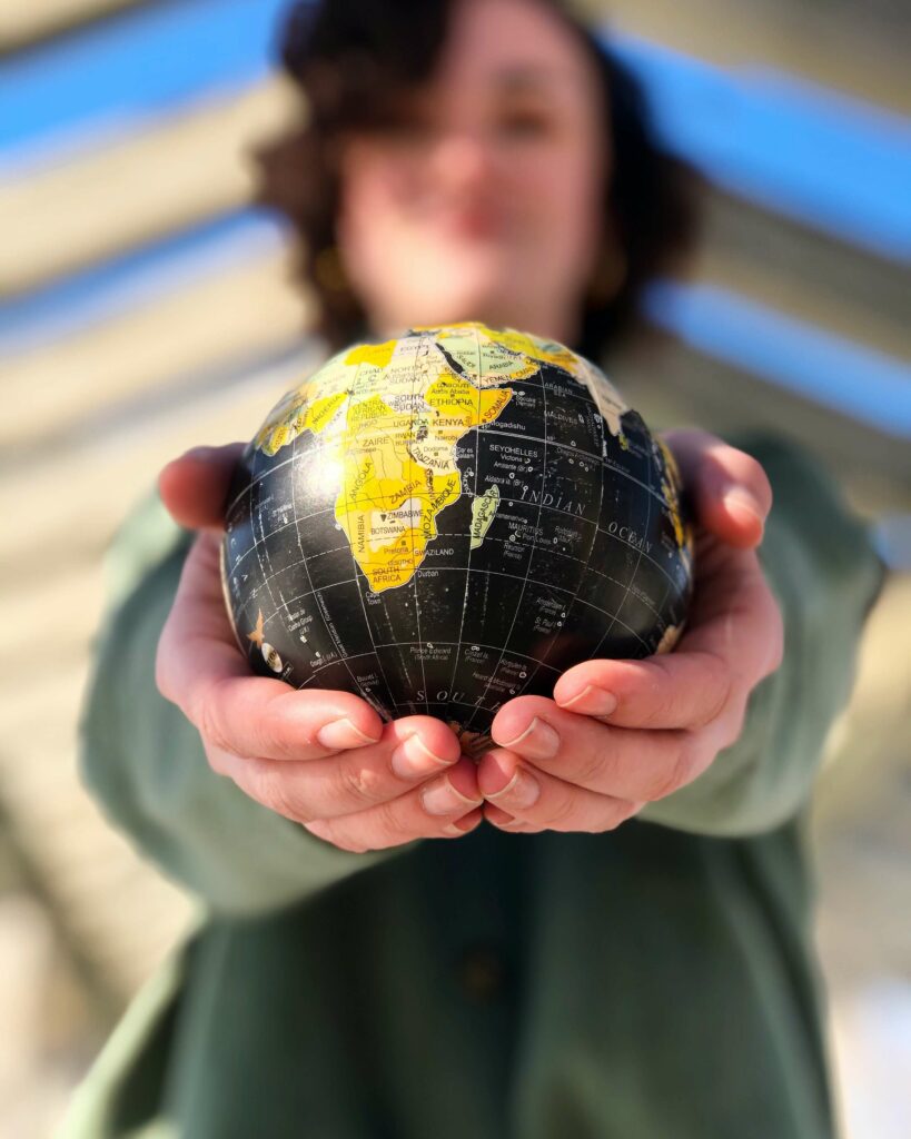 Woman holding a small globe (local SEO)