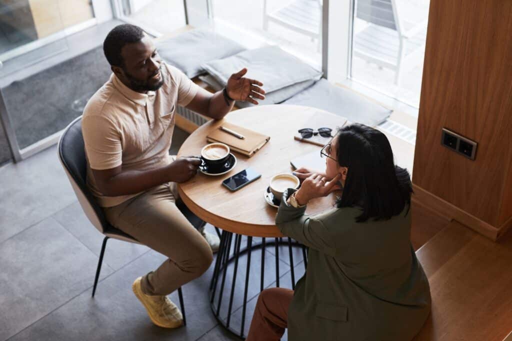 Business owners discussing marketing data and business intelligence over coffee