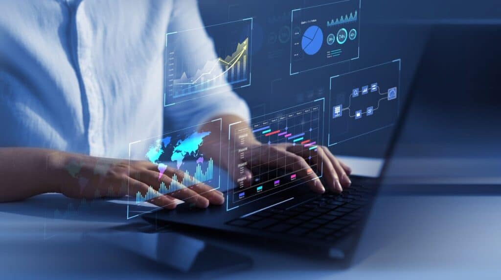 Man typing on a laptop which shows marketing data