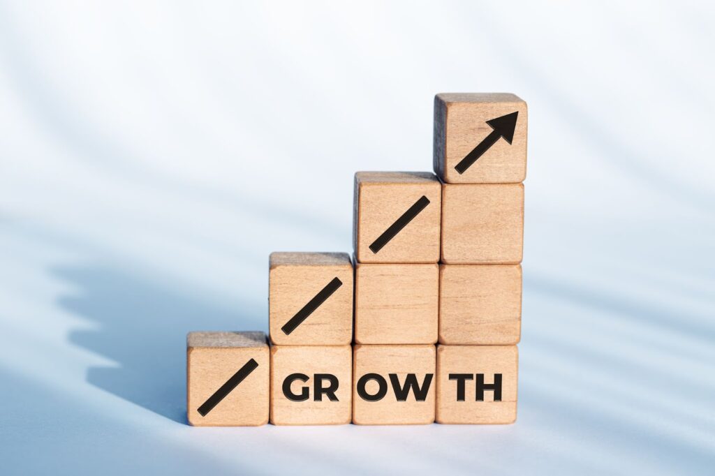 Blocks stacked on top of each other spelling the word "growth"