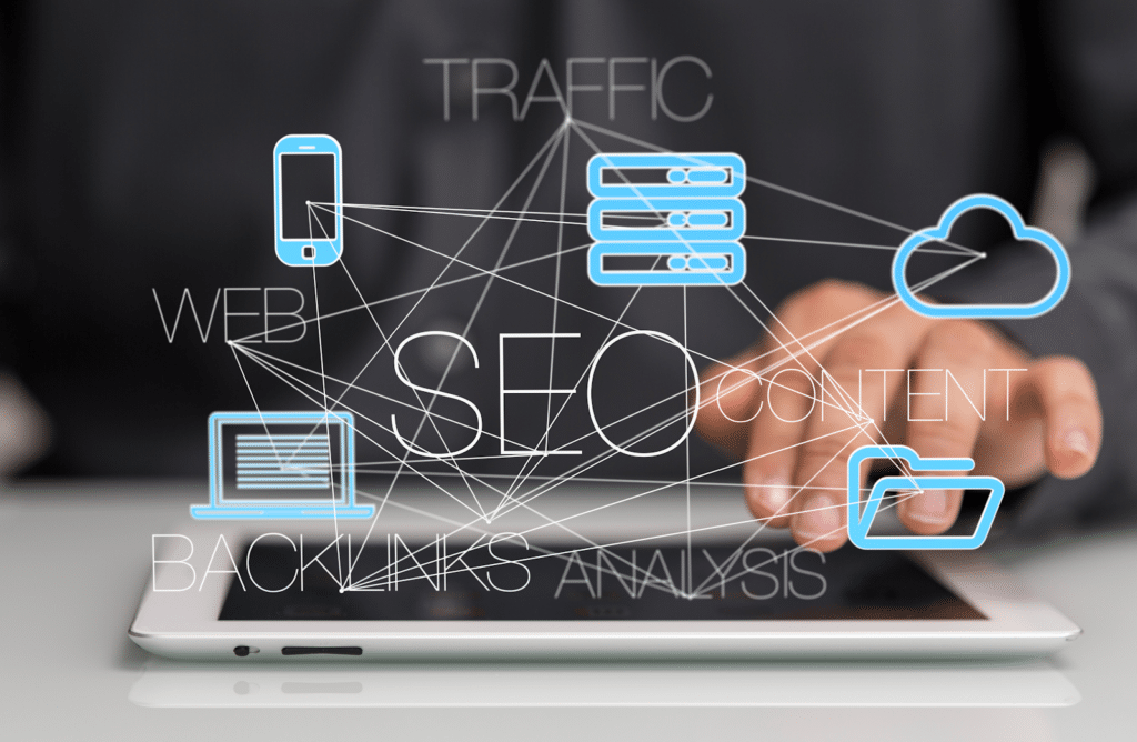 Hands using a tablet, overlayed with the words "SEO", "Web" "Content", "Backlinks", "Analysis", and "Traffic".