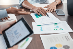 Marketers going over cohort analysis data at a table