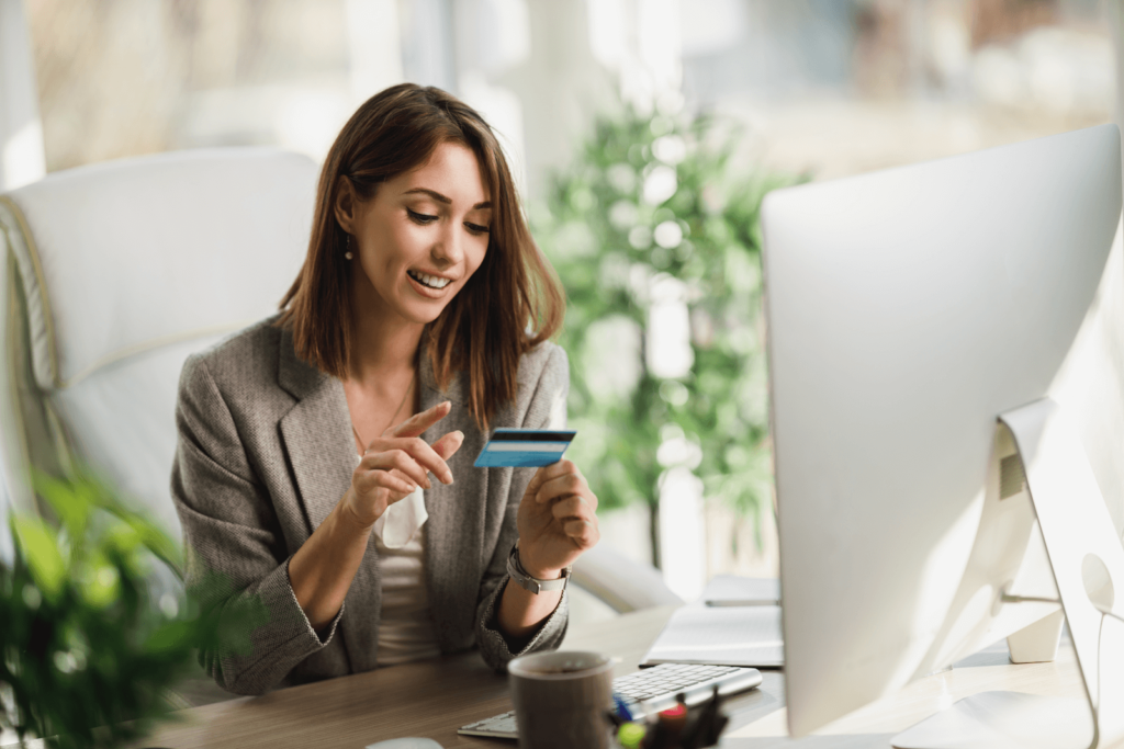 Marketer looking at a credit card at her desk