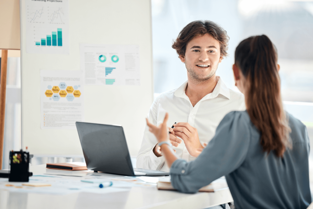 Marketers discussing cohort analysis data taped to a marker board