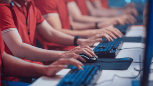 Agents in red shirts typing on keyboards (click bots)