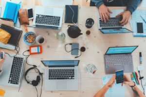 Overview of markers at a table with laptops discussing inbound marketing