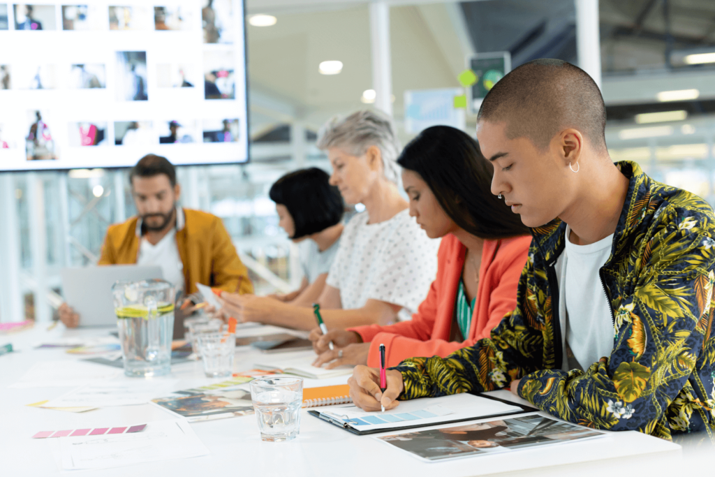 Five marketers at a table with notebooks and pens