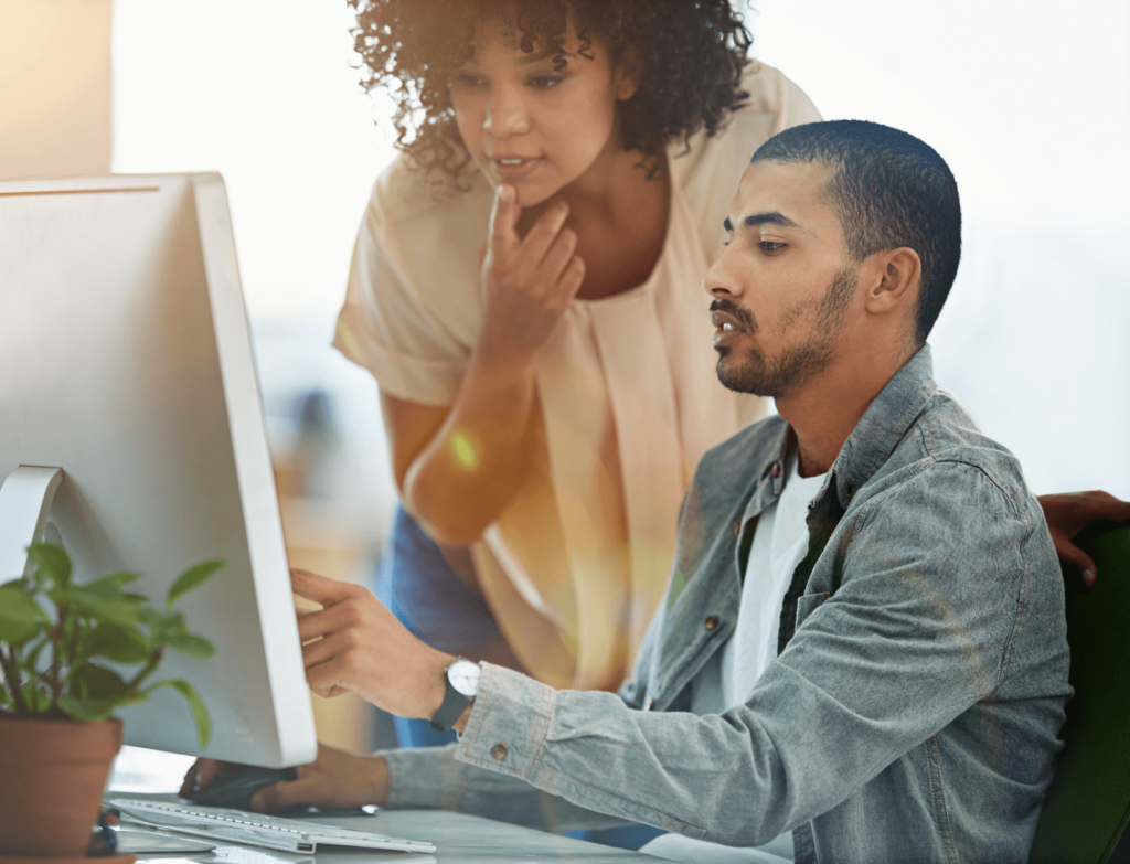 Two marketers looking at a monitor displaying their PPC campaign