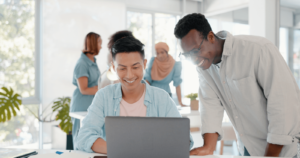 Two marketing managers discussing local ppc with a laptop