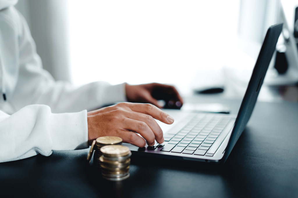 Hands typing on a laptop on a desk (local PPC campaigns)