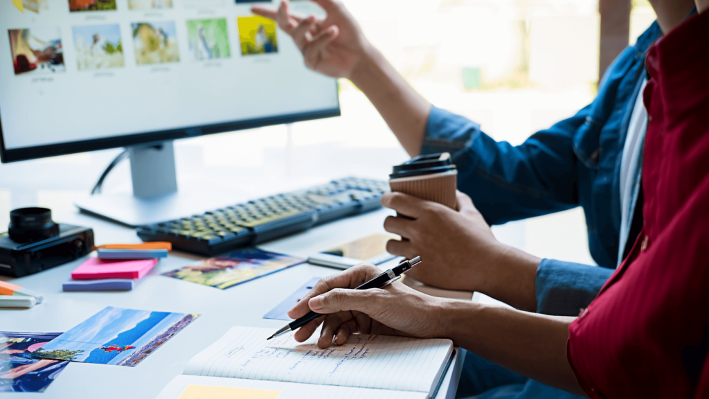 Marketers writing advertising copy on a computer