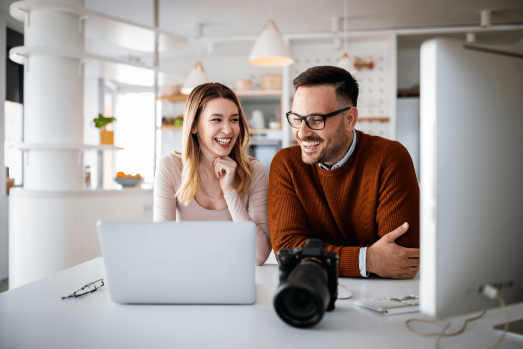 Two professionals looking at a laptop (web maintenance spring texas)