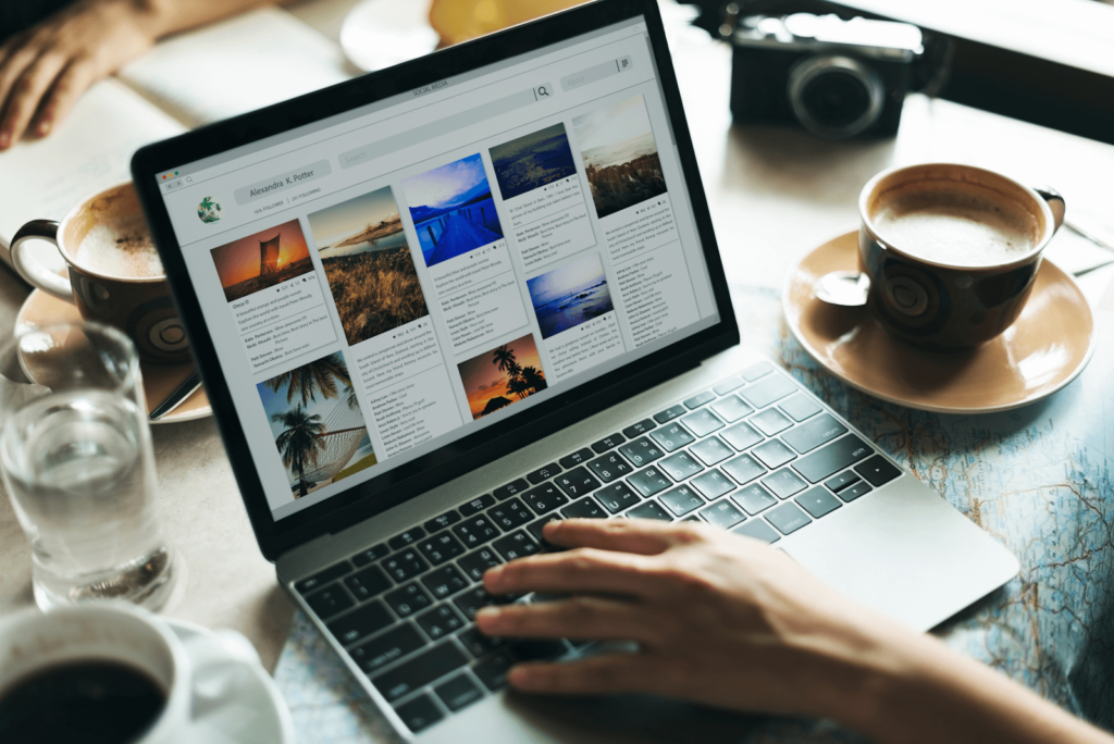 A person with coffee and an open laptop