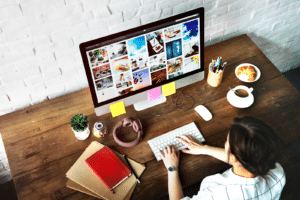 Marketer at a table with a monitor (Content Gap Analysis)