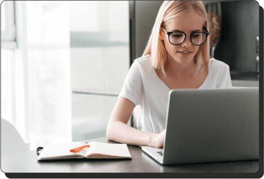 Woman typing on a laptop, searching for marketing consulting services