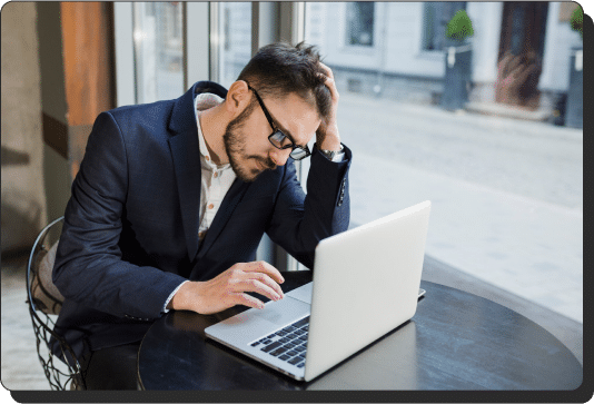 Frustrated man in front of a laptop