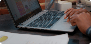 Hands typing on a laptop (Marketing Teams Services)