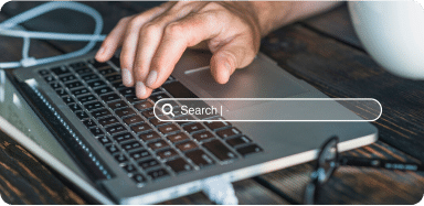 Hand typing on a laptop