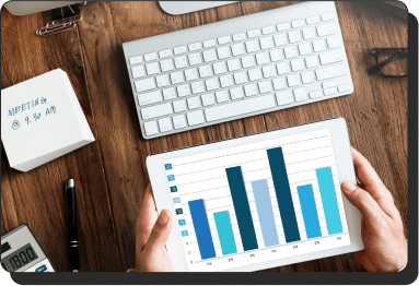 Person with a tablet looking at a bar chart