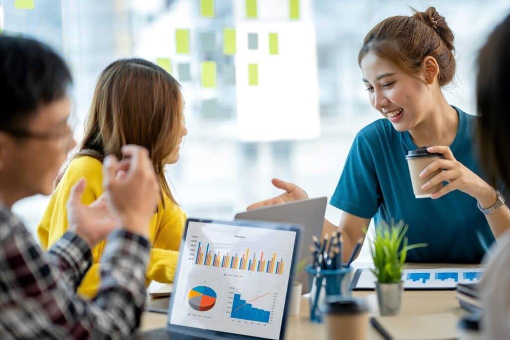 Young professionals working on laptops showing marketing automation
