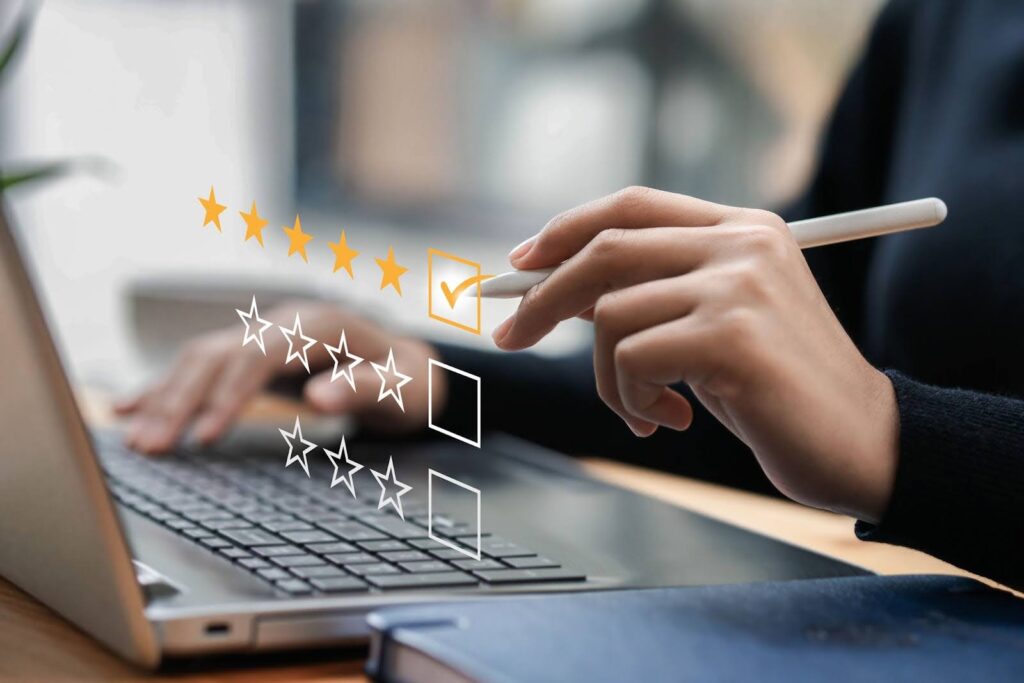 Five star gold check mark above laptop for QA testing