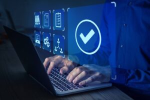 Website QA testing on a laptop with checkmark illuminated