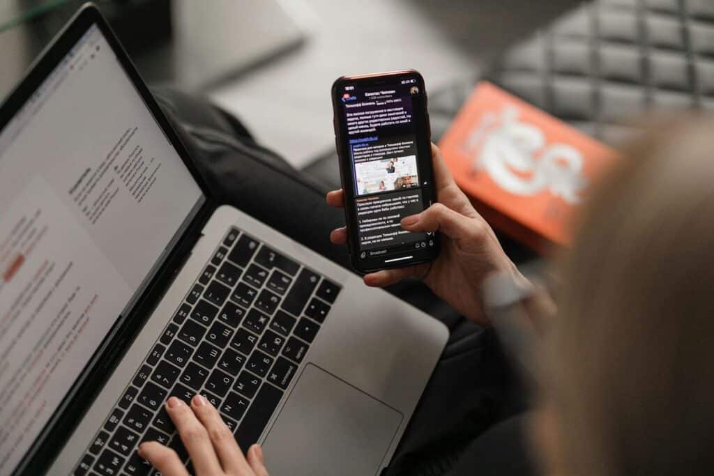Woman on computer and phone experincing poor customer service