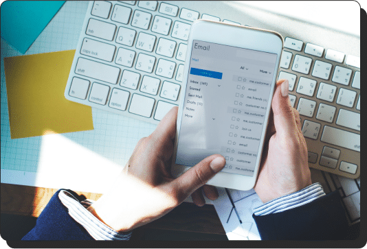 Person holding a phone with an email application open
