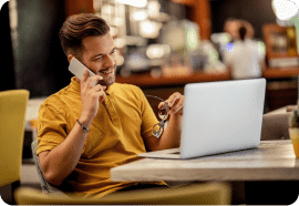 Man on the phone with a laptop discussing email marketing