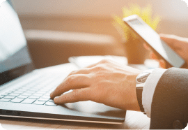 Hands typing on a laptop