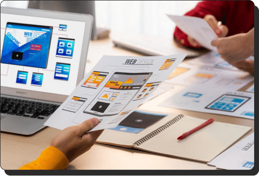 Marketers holding website design mockups